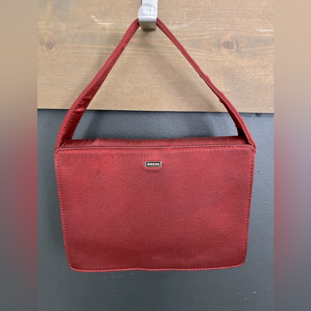 Authentic Gucci red satin evening bag. Silver hardware and snap closure.